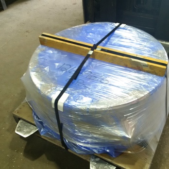 A large metal container covered by transparent VCI Stretch Film (polyethylene-like film)